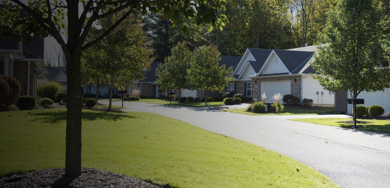 a path with buildings on the side of a road