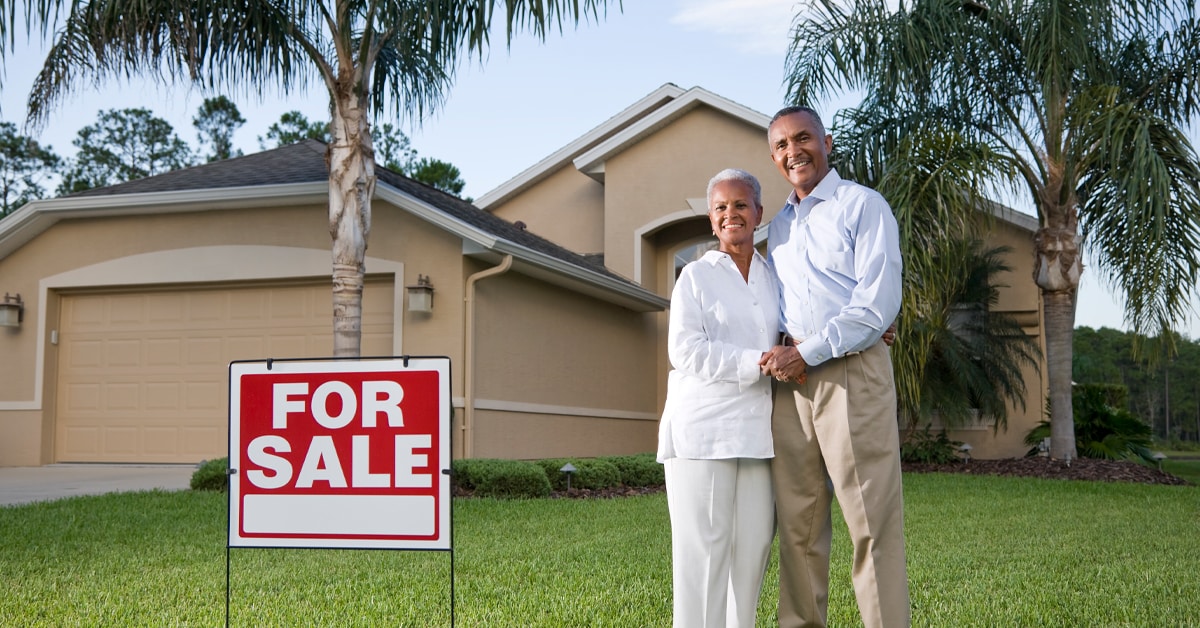 A Man Standing In Front Of A House