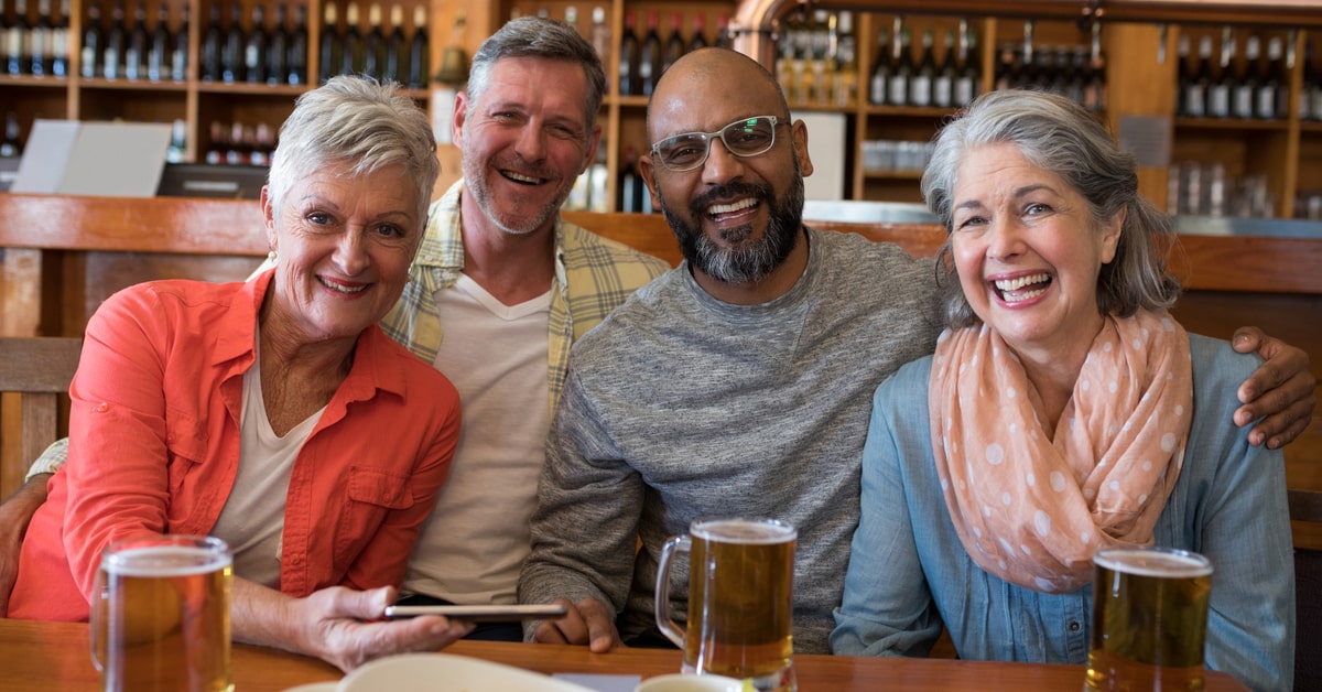 A Group Of People Sitting At A Table In A Restaurant