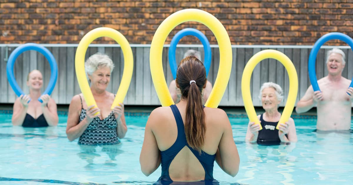 A Group Of People In A Pool Of Water