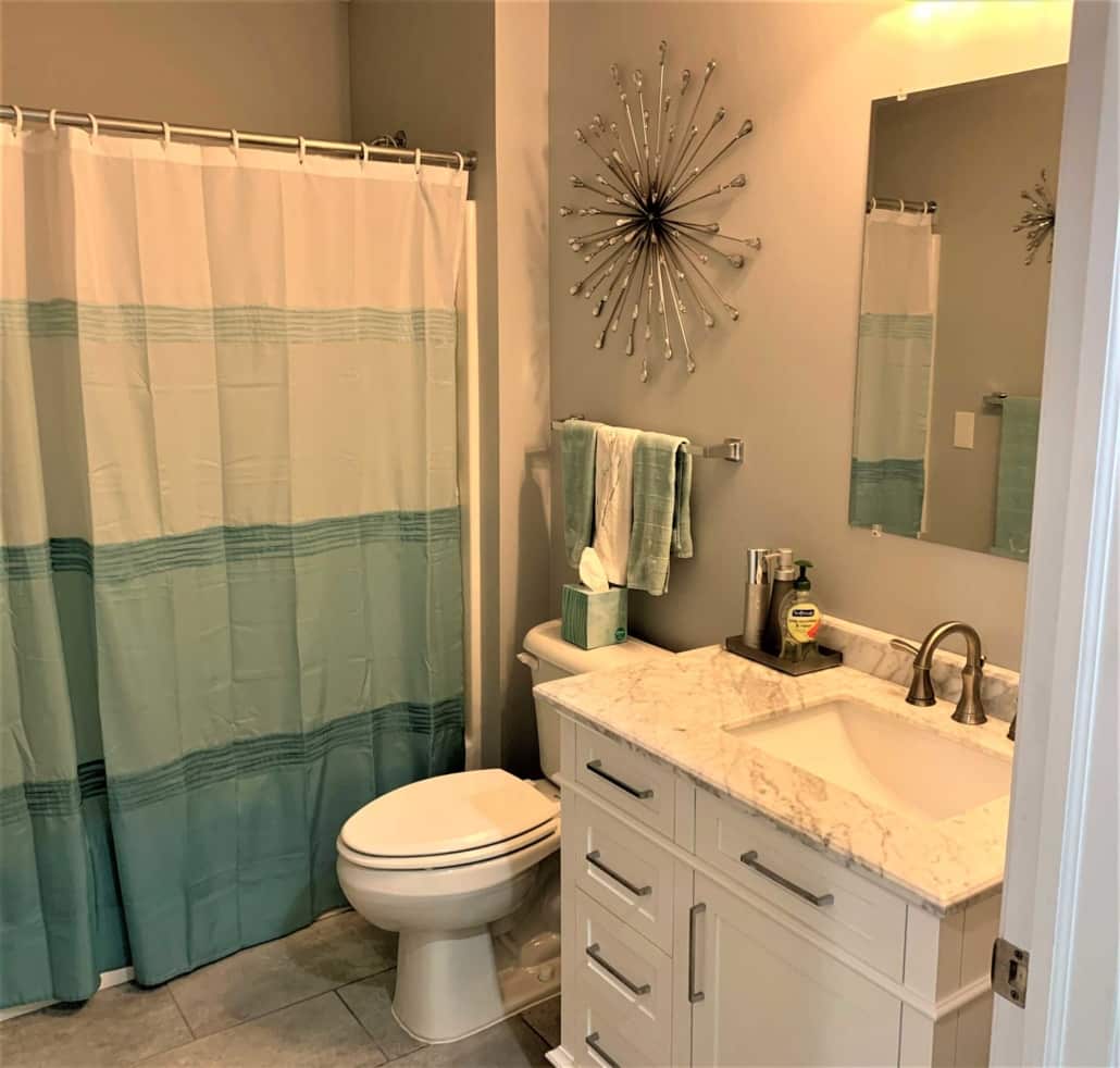 A Shower Curtain Next To A Sink