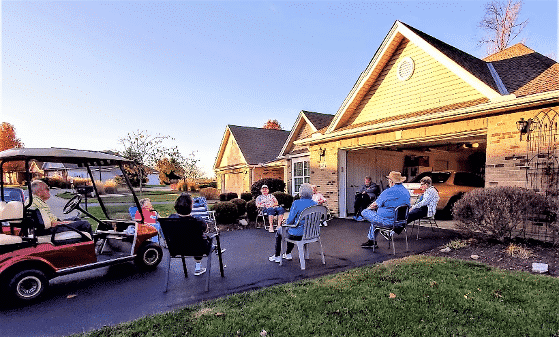 A Group Of People Standing In Front Of A House